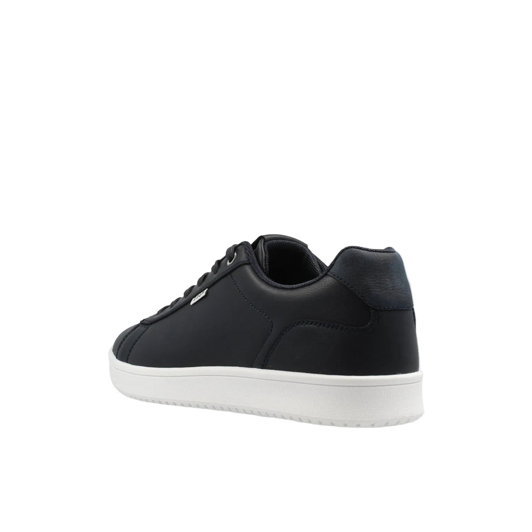 Black sneaker with white sole on a light gray background