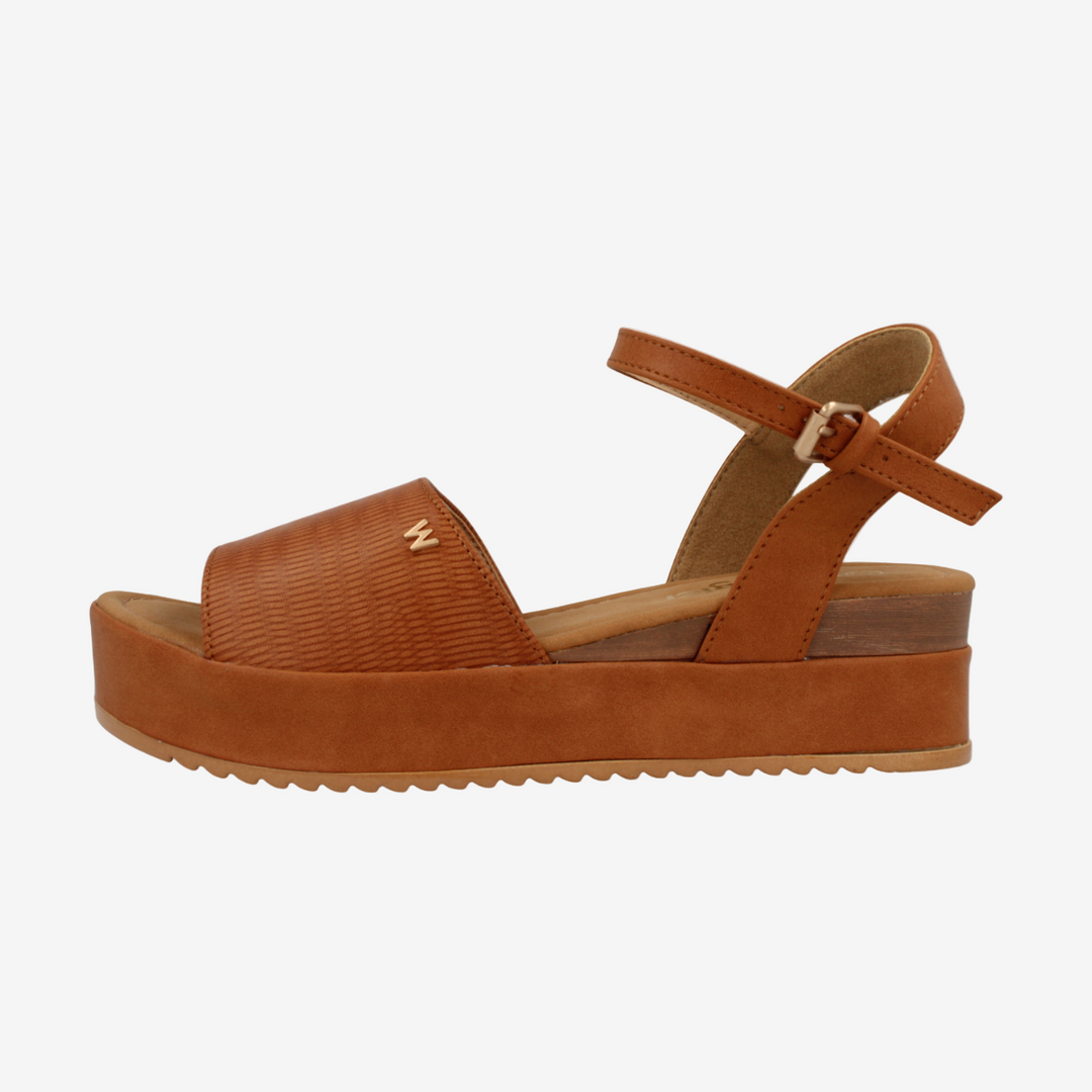 Brown sandal with platform sole on a white background