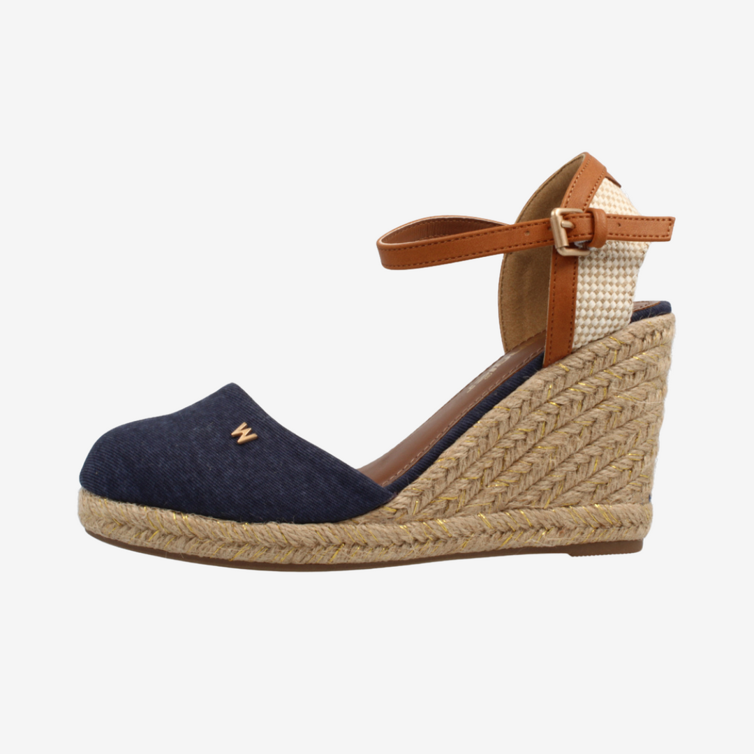 Navy wedge sandal with brown strap on a white background