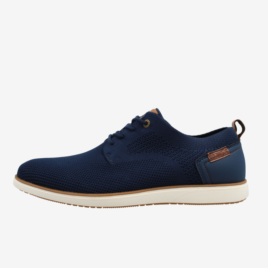 Navy blue shoe with a white sole on a light gray background