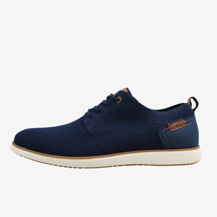 Navy blue shoe with a white sole on a light gray background
