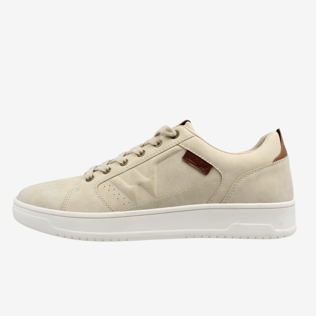 Beige sneaker with a brown patch on a white background