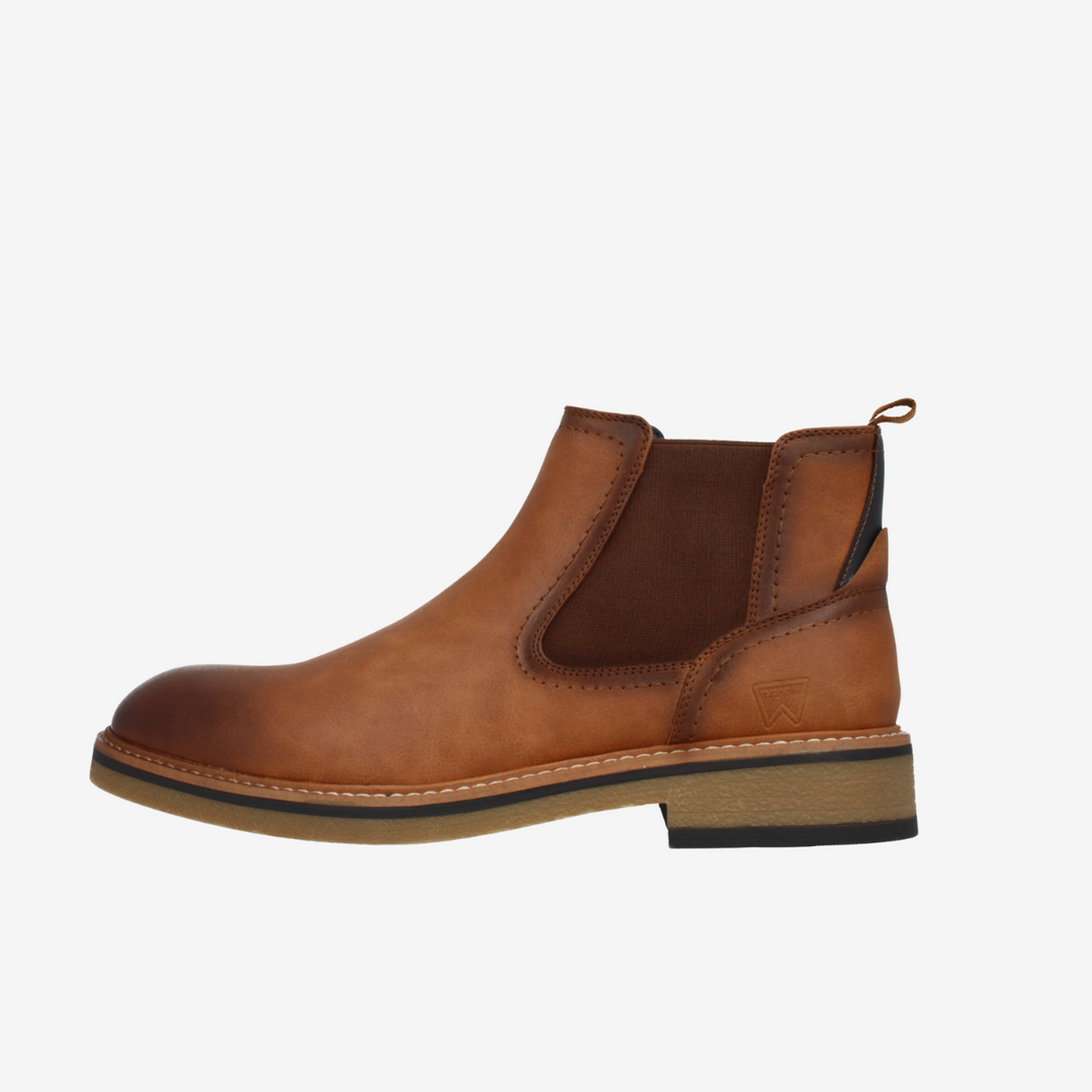 Brown leather Chelsea boot on a white background