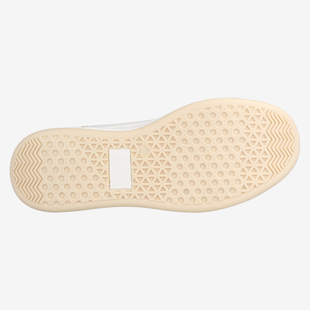 Close-up of a beige shoe sole with a white background