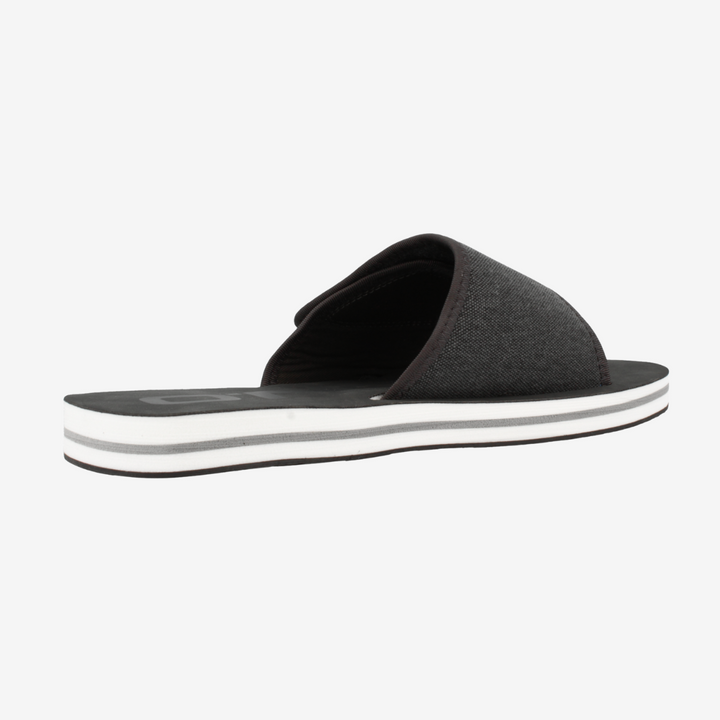 Black slide sandal with a white sole on a light gray background