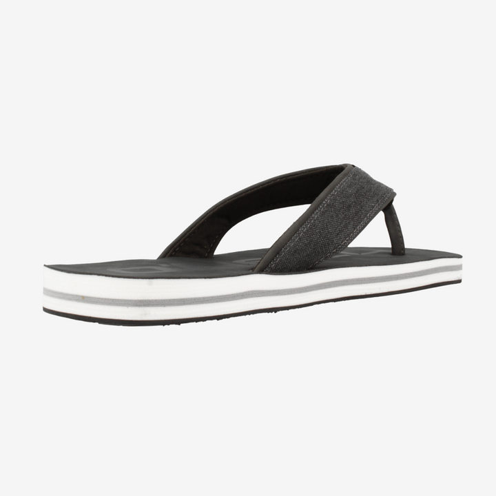 Black and white sandal on a light gray background