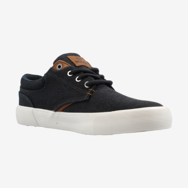 Black sneaker with white sole on a light gray background