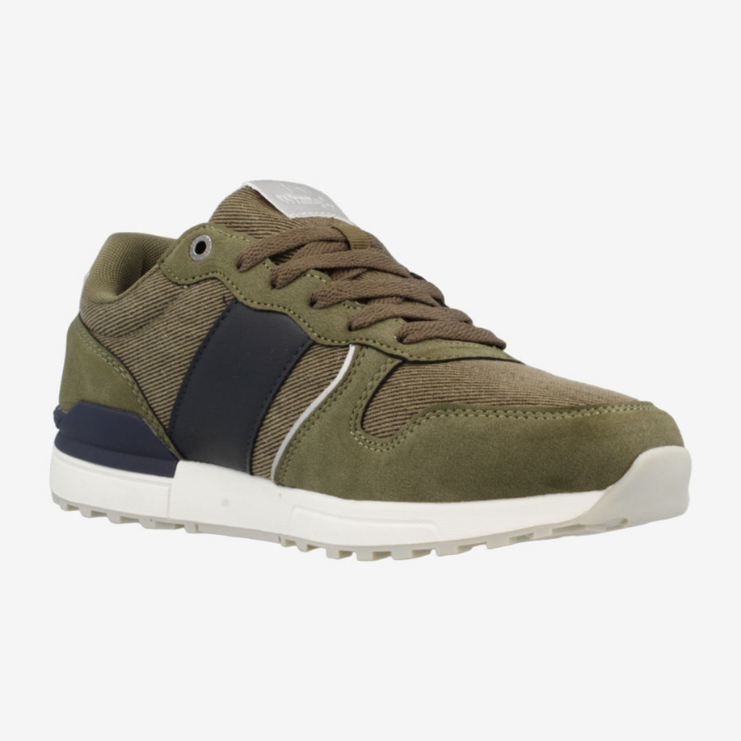 Green sneaker with black accents on a white background