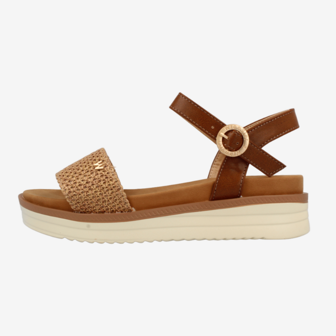 Brown sandal with a platform sole on a white background