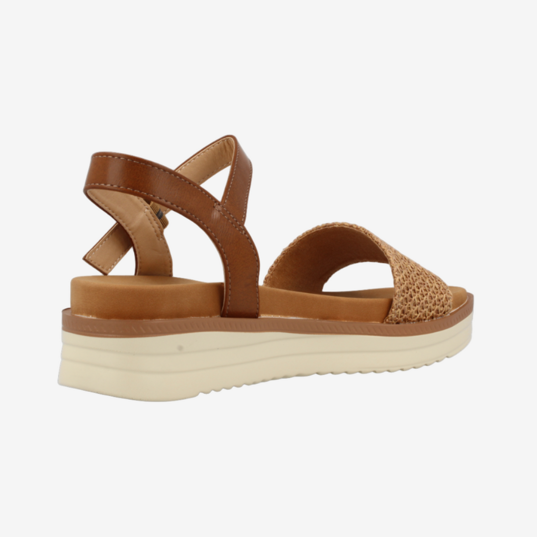 Brown sandal with a platform sole on a white background