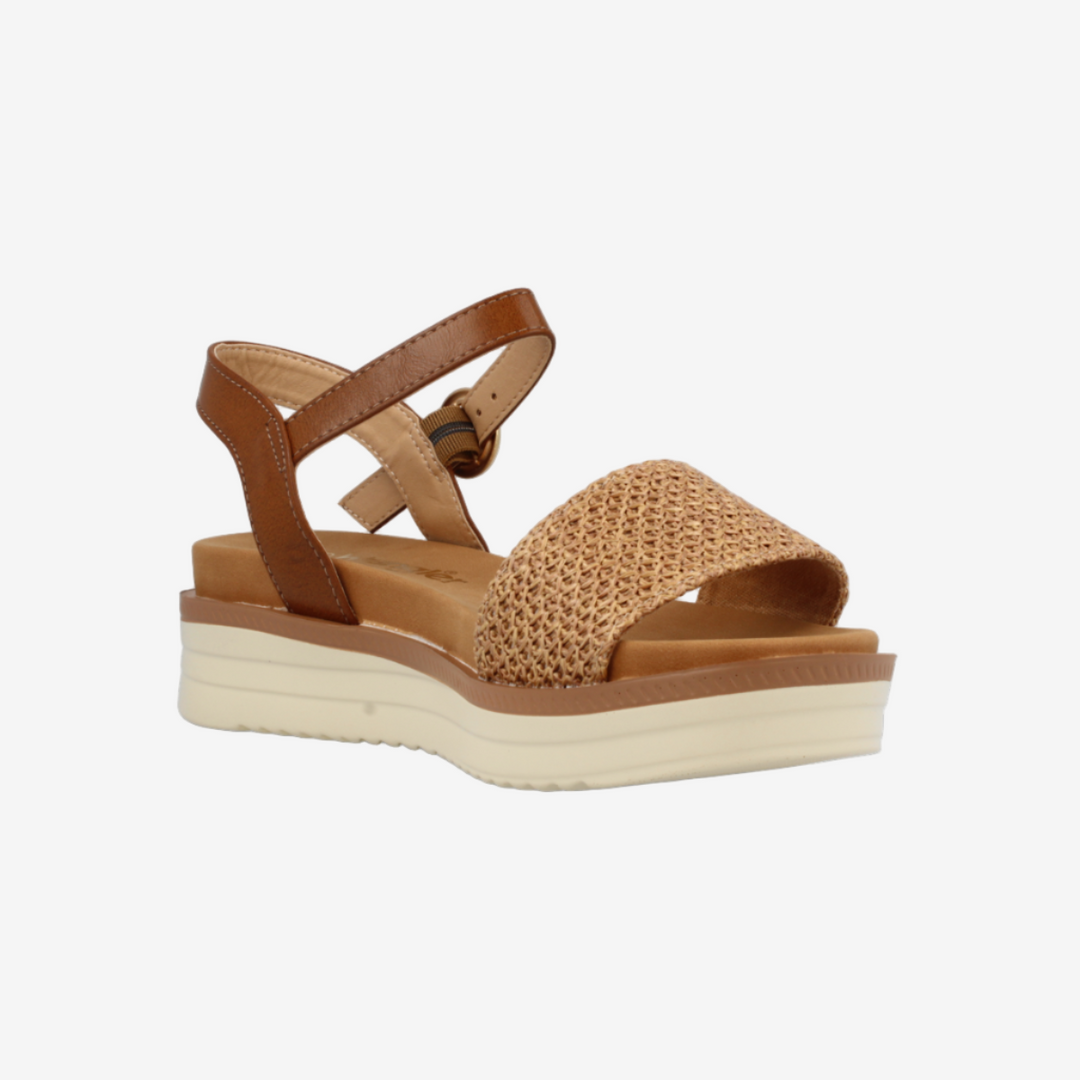 Tan sandal with a platform sole on a white background