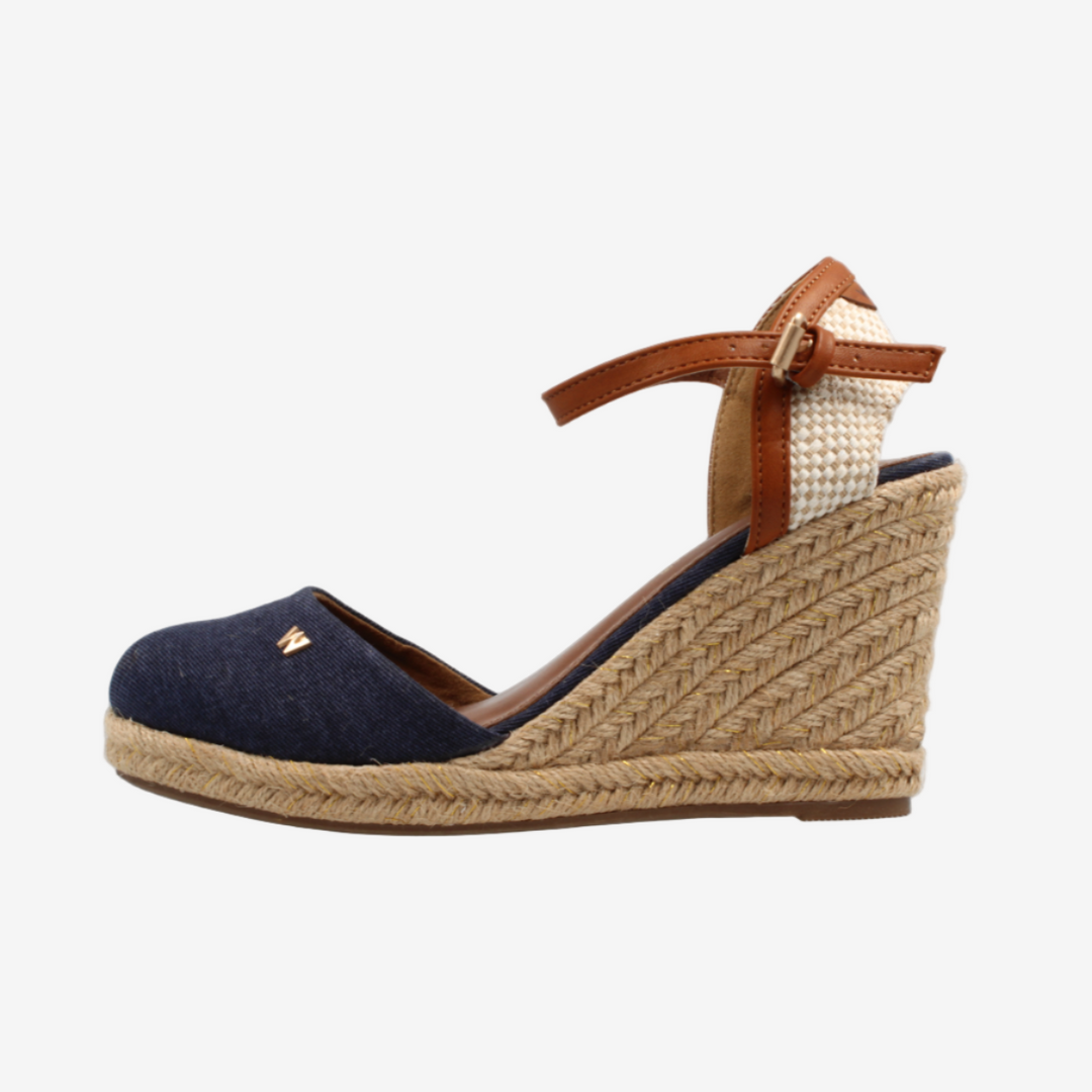 Navy wedge sandal with brown strap on a white background