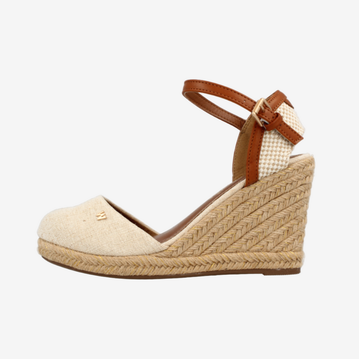 Beige wedge sandal with brown strap on a white background