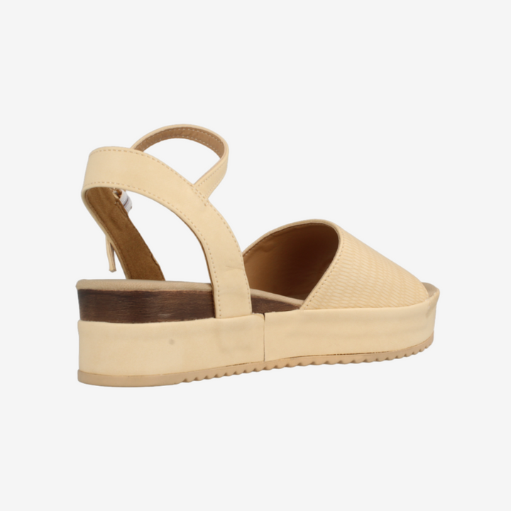 Beige sandal with a wedge sole on a white background