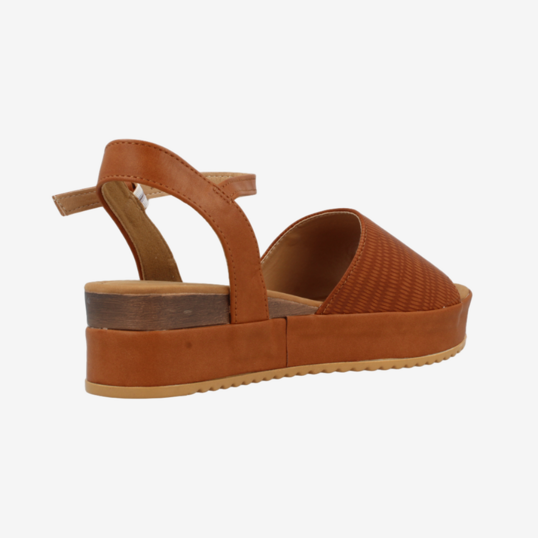 Brown sandal with a platform sole on a white background