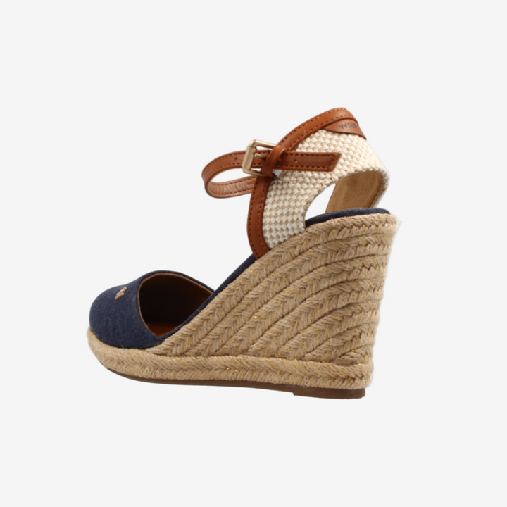 Wedge sandal with jute sole and brown strap on a white background