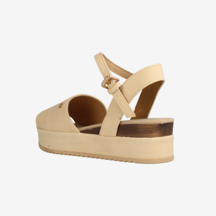 Beige sandal with a platform sole on a white background