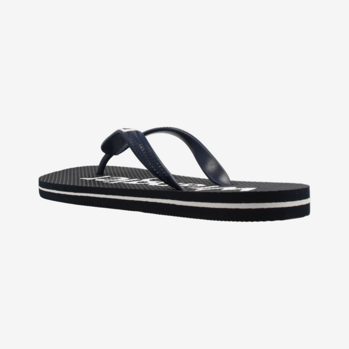 Navy blue sandal with white sole on a light gray background