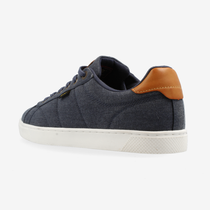 Navy blue sneaker with brown heel tab on a white background