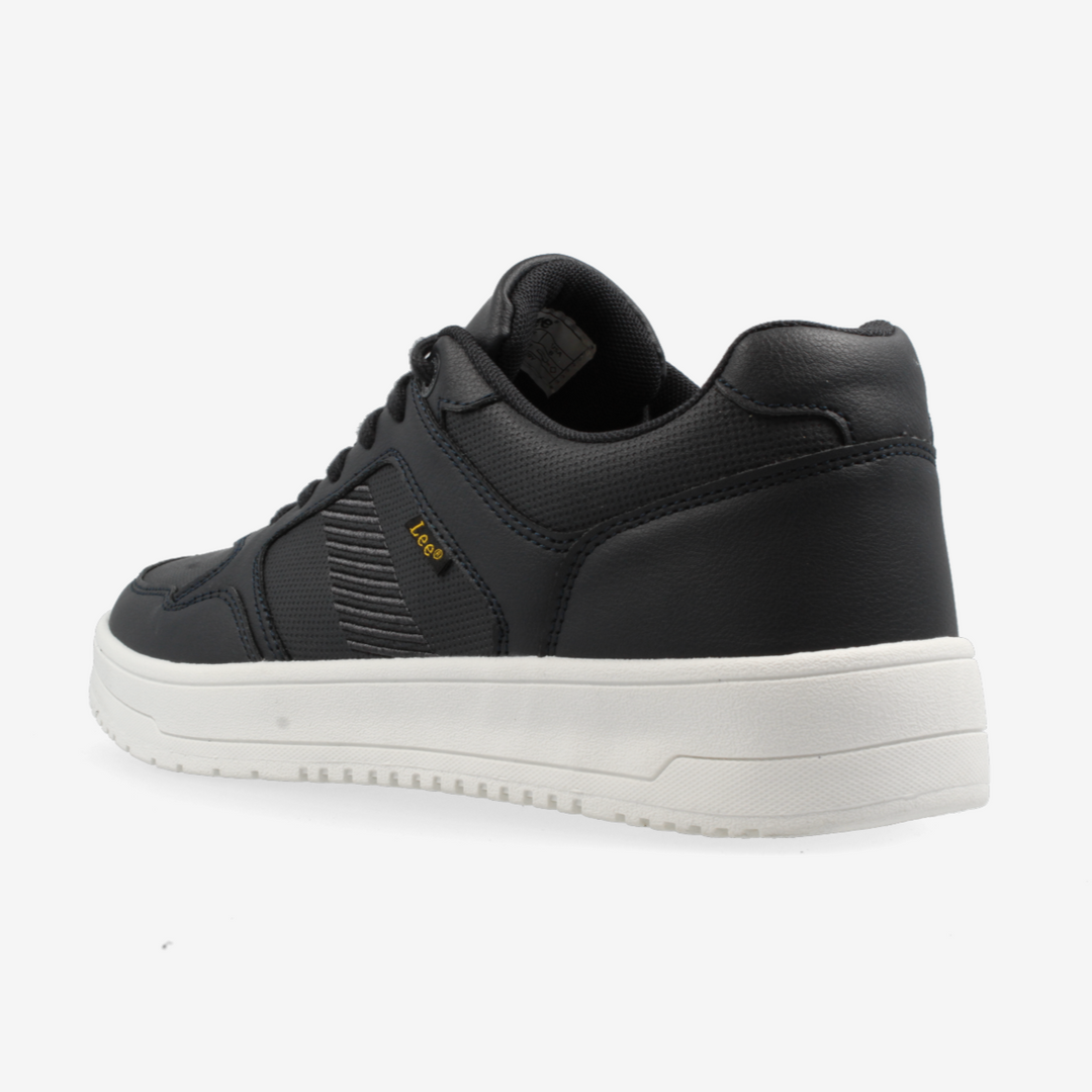 Black sneaker with white sole on a light gray background