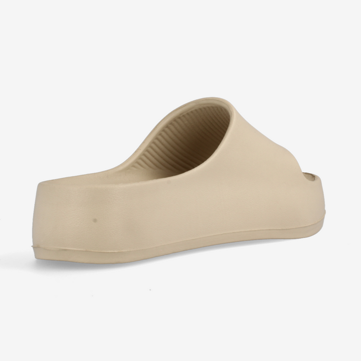 Beige slip-on shoe on a white background