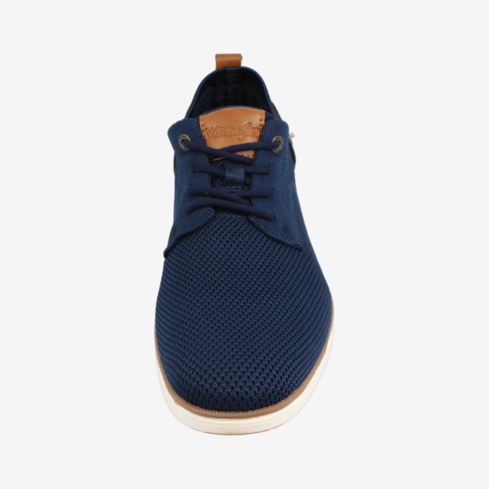 Navy blue sneaker with a white sole on a white background