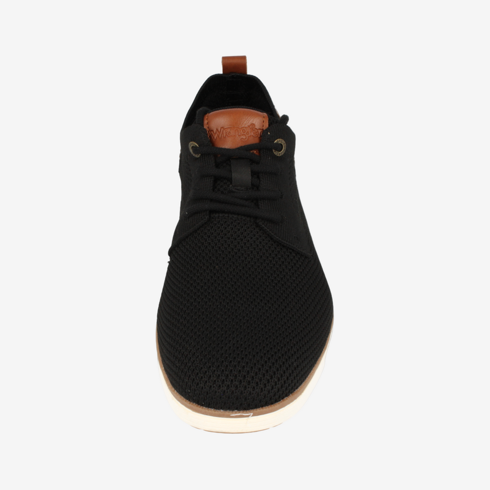 Black sneaker with a brown sole on a white background