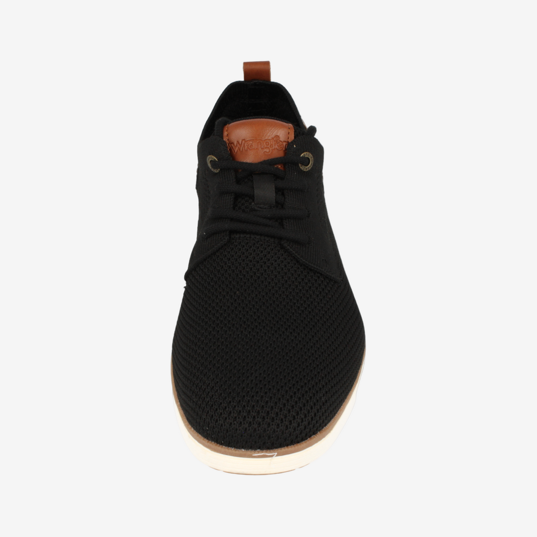 Black sneaker with a brown sole on a white background