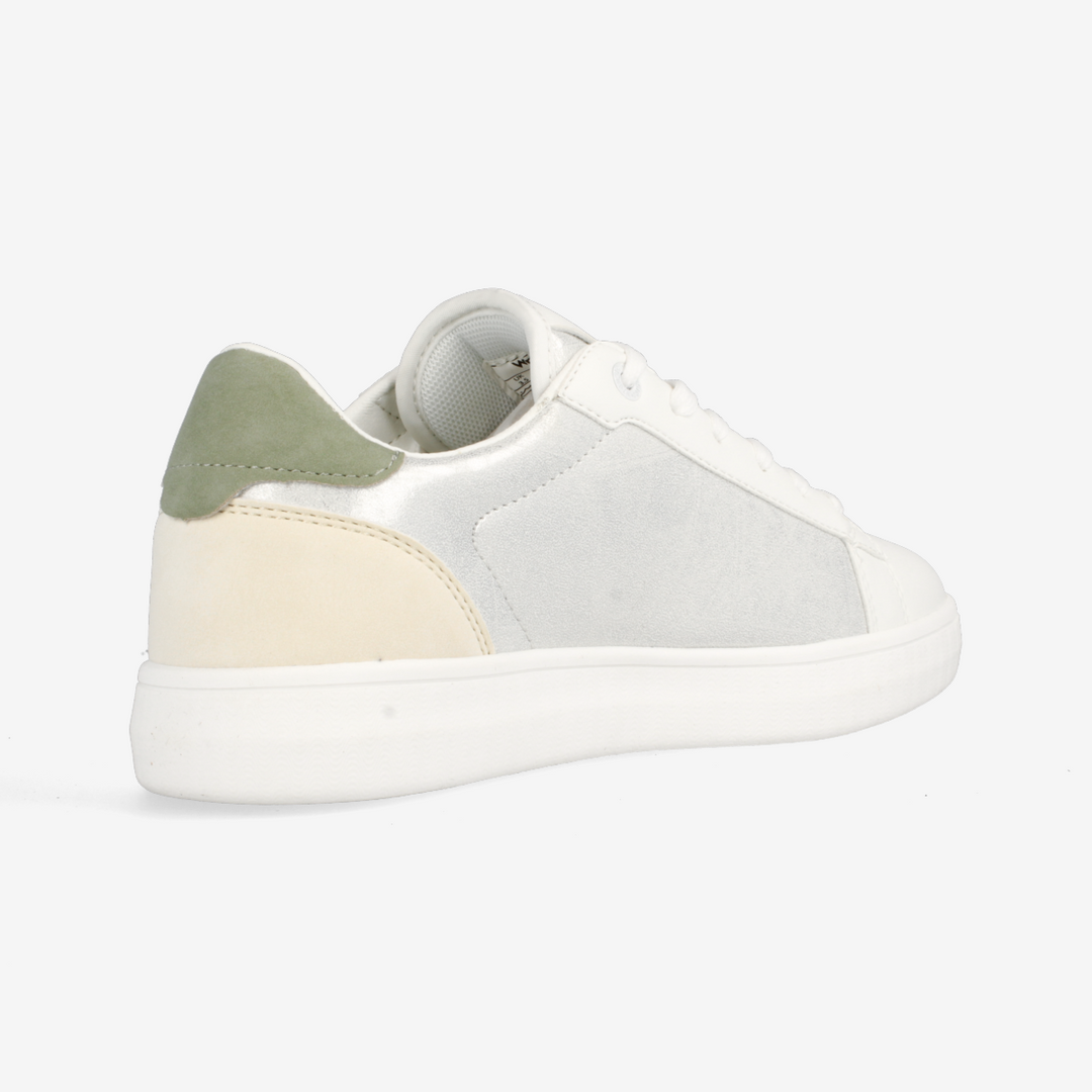 White sneaker with green and beige accents on a white background