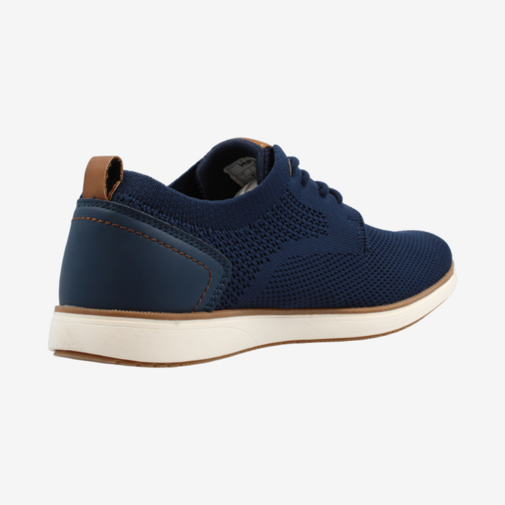 Navy blue sneaker with white sole on a light gray background