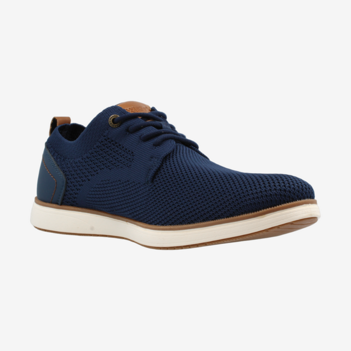Navy blue sneaker with white sole on a light gray background