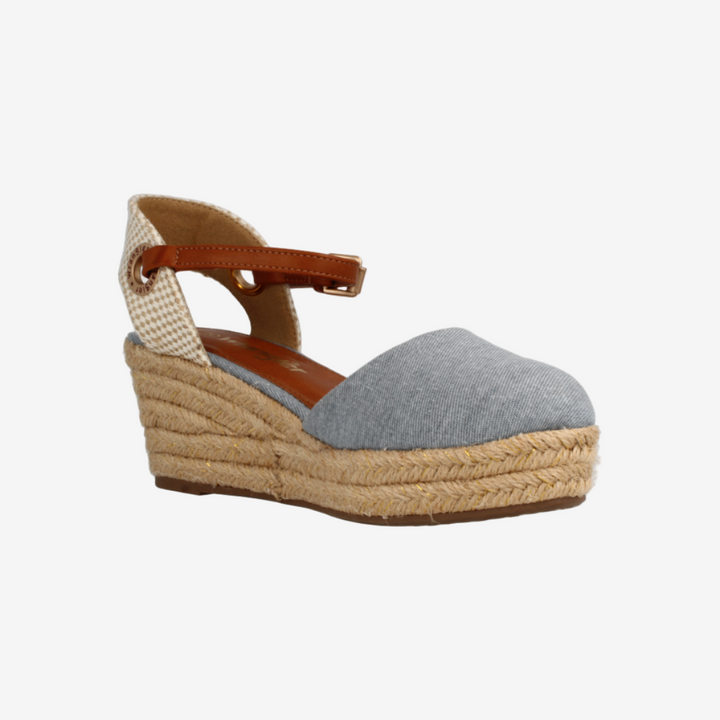 Wedge sandal with espadrille sole on a white background