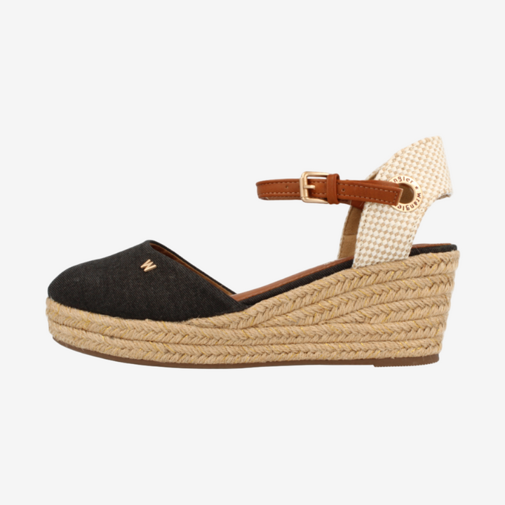 Black wedge sandal with woven sole on a white background