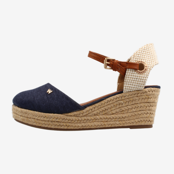 Navy wedge sandal with a brown strap on a white background