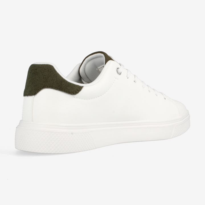 White sneaker with green accents on a white background