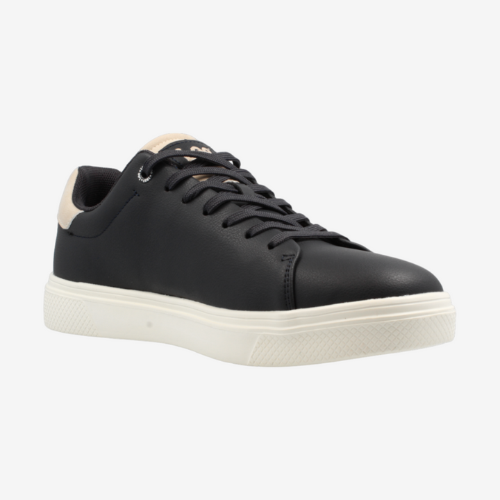 Black sneaker with white sole on a light gray background