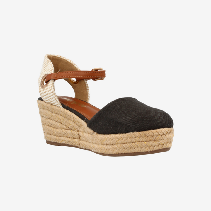 Wedge sandal with black suede upper and beige espadrille sole on a white background