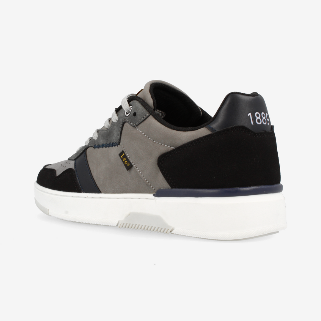 Gray and black sneaker with white sole on a light gray background
