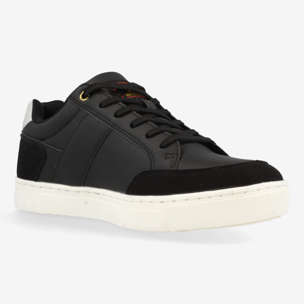 Black sneaker with white sole on a light gray background